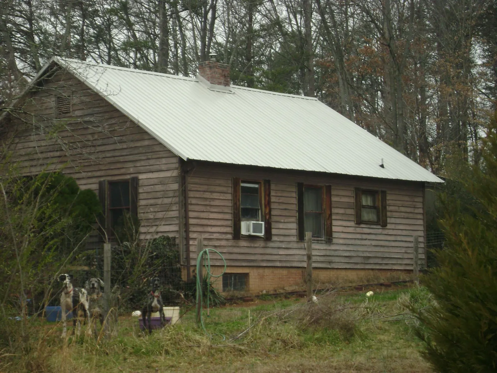 White metal roof on an old wood sided farmhouse, from a Asphalt Shingle Roof Repair job in Winchester